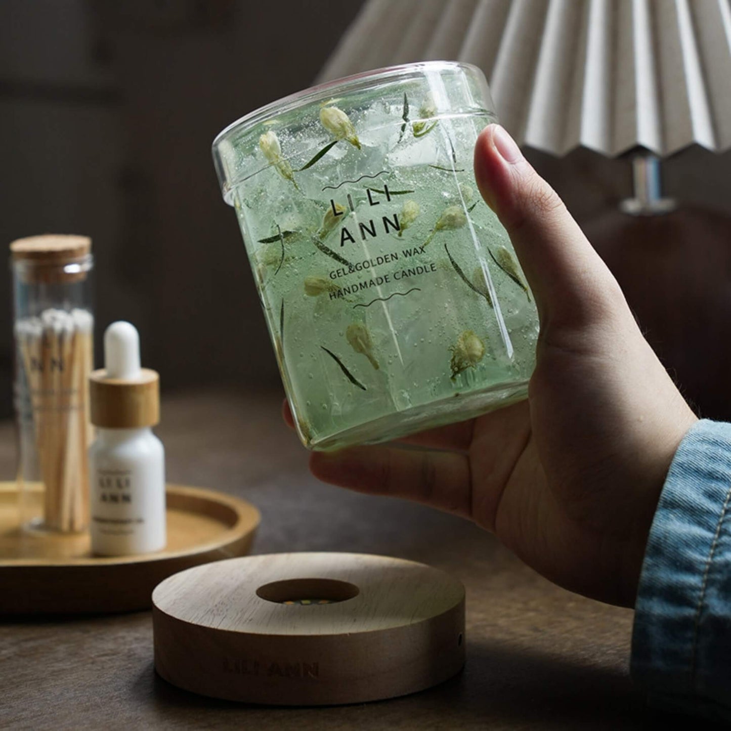 A hand holding the substantial Gel Object .10, showing the permanent suspension of real botanical specimens.