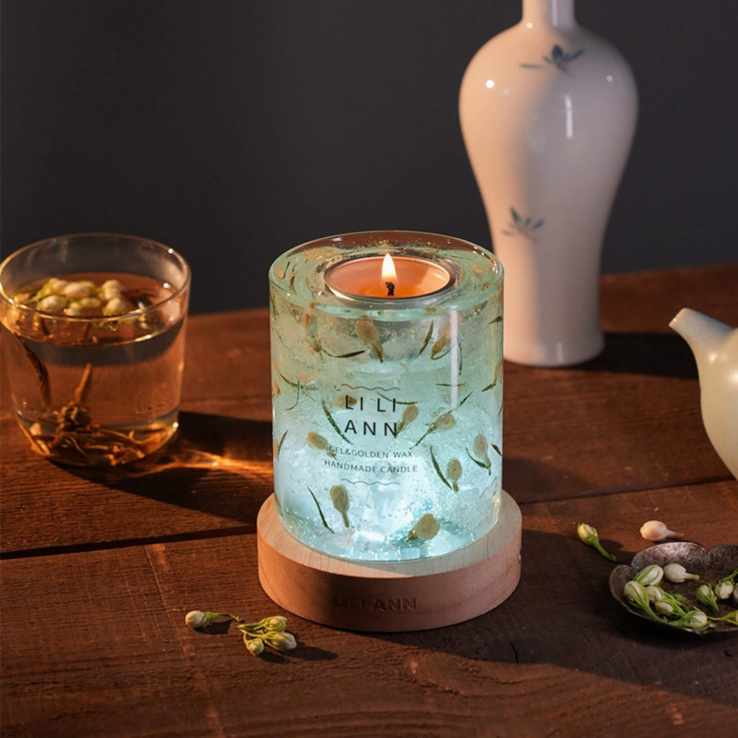 Liliann Gel Object .10 illuminated from below. The translucent vessel glows with a lunar jade light, highlighting the embedded leaves.