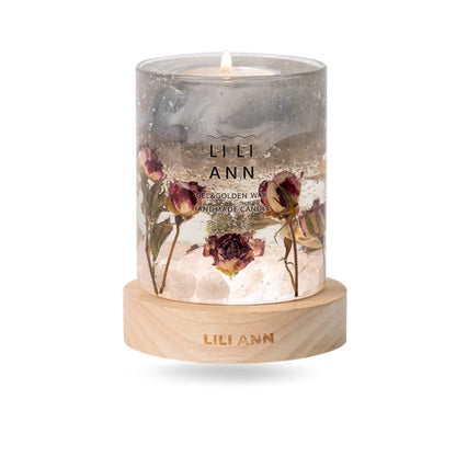 Close-up of clear gel wax containing faux rose stems rooted in a bed of white stones.