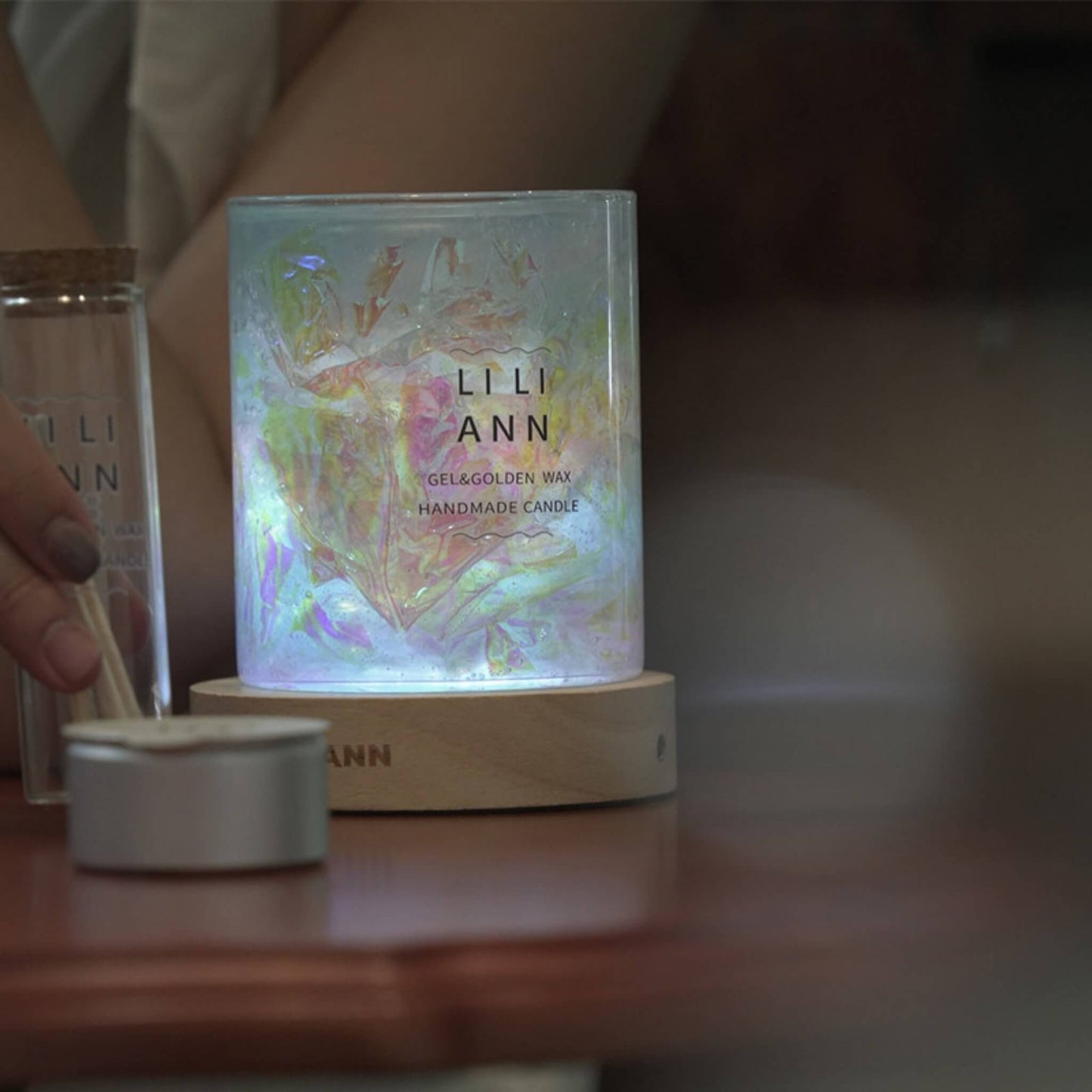 Object .13 lit in a dark room, projecting a fractured, kaleidoscope-like pattern of light onto the surrounding surface.