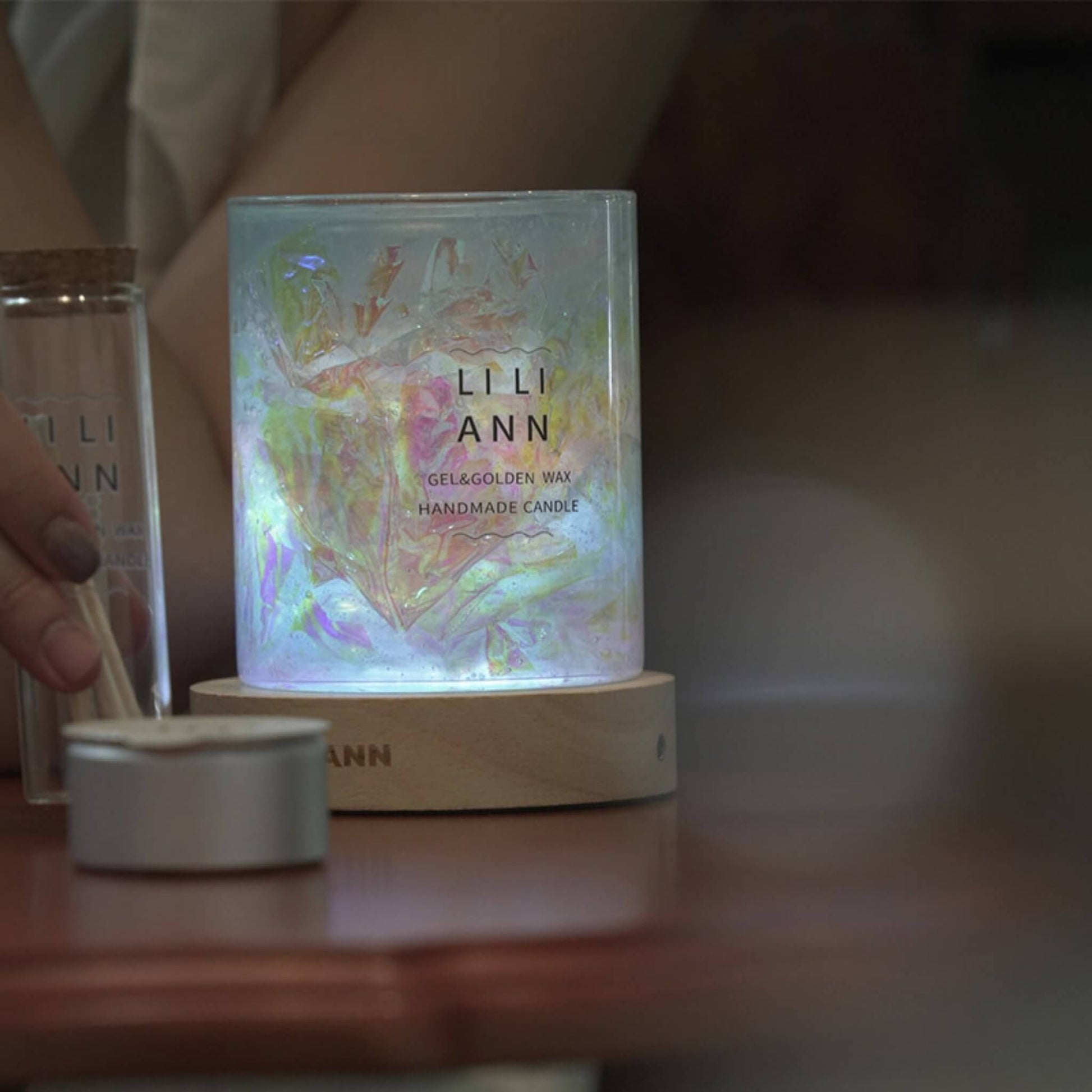 Object .13 lit in a dark room, projecting a fractured, kaleidoscope-like pattern of light onto the surrounding surface.