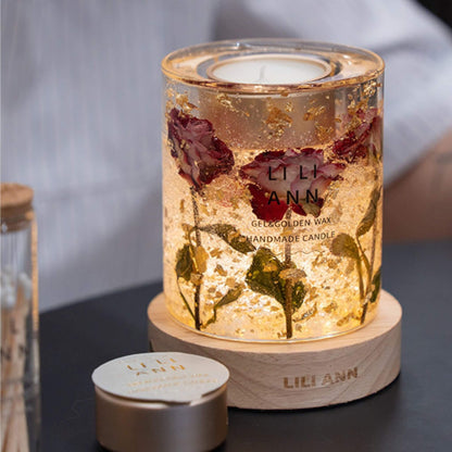 Illuminated Muse Vessel emitting a warm amber glow, highlighting the preserved rose petals and gold leaf inside.